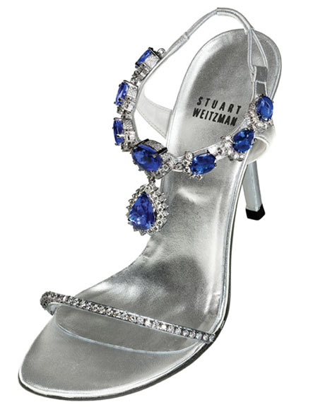 Pictured above is a $2 million sandal from Stuart Weitzman that was sported at the Le Vian party in Las Vegas. The silver leather designer heels flaunt 185 carats of tanzanite and 28 carats of diamonds. The frontage strip sports a slim belt of diamonds with fitted profound gemstones to arc around the ankle with a 16 carat pear-shaped tanzanite plunge bordered by diamonds that swings over the face of the foot. The stones on the sandals seem to be mounted unswervingly onto the leather and hardly seem to be detachable. 